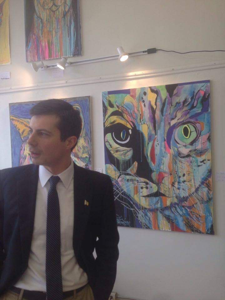 pete buttigieg looking at Russell frantom artwork 
