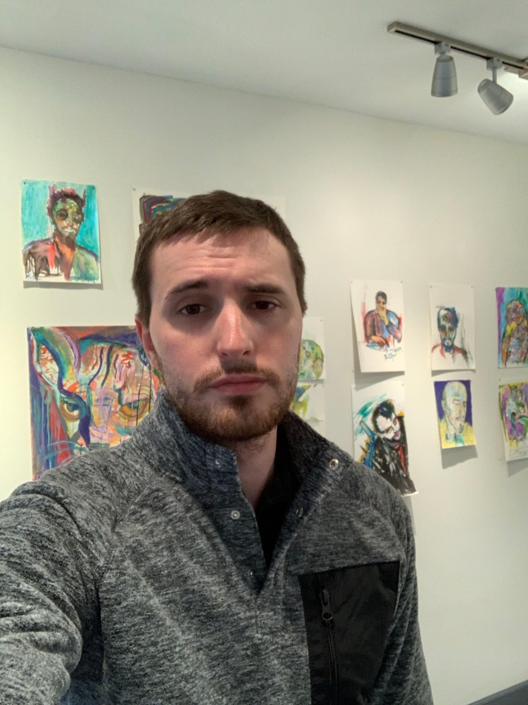 Artist Russell frantom shows off his colorful artwork in the art gallery 
