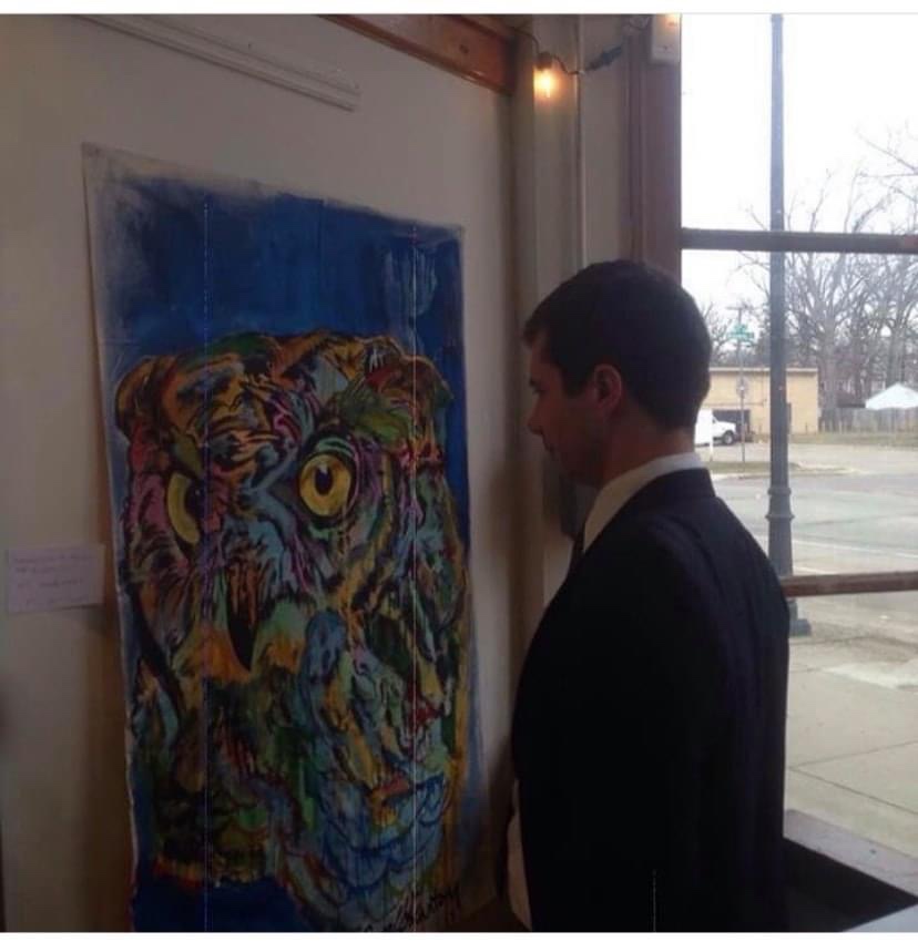 pete Buttigieg looking at artwork by Russell frantom 