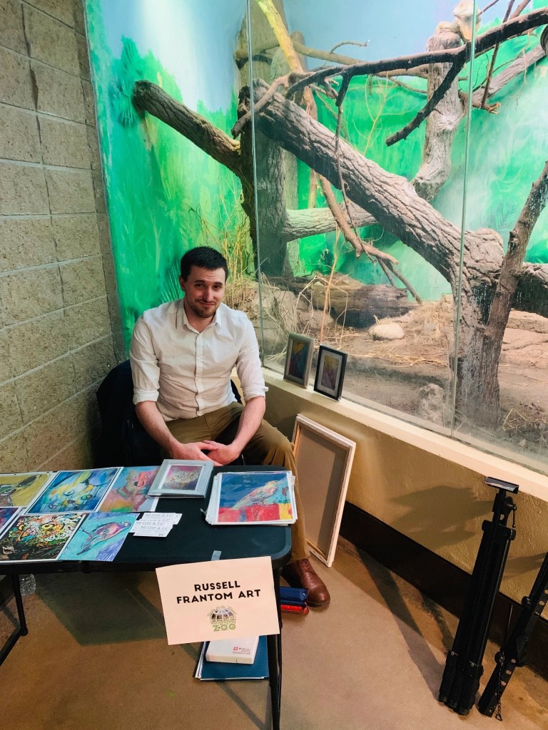Artist Russell frantom gives away art prints at an event for earth day at Potawatomi zoo in south bend Indiana, 2018 ​