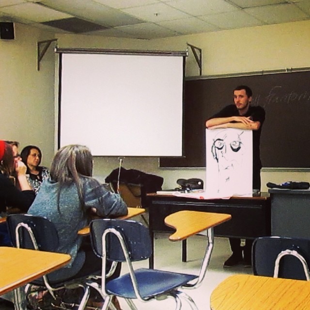 Artist Russell frantom paints and guest speaks in a class at Indiana university south bend ​
