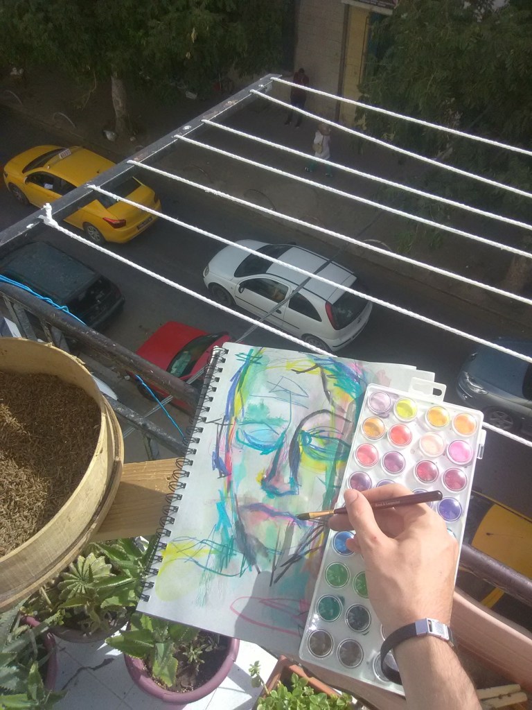 Artist Russell frantom paints an abstract portrait on a balcony in Tunisia Africa 2018 ​