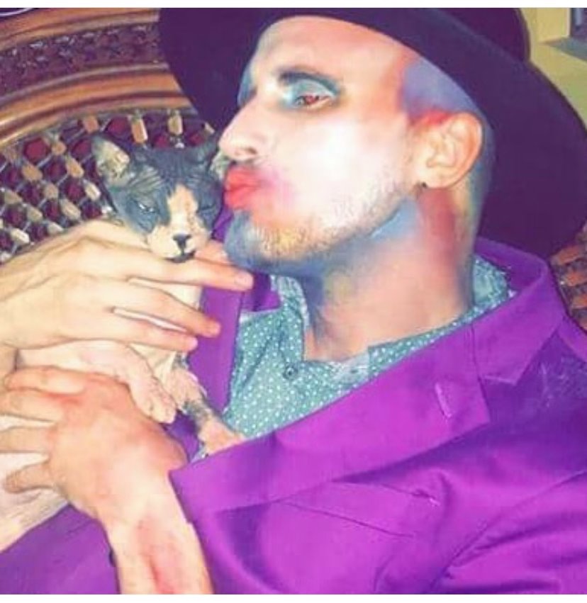 Artist Russell frantom with his Sphinx cat 