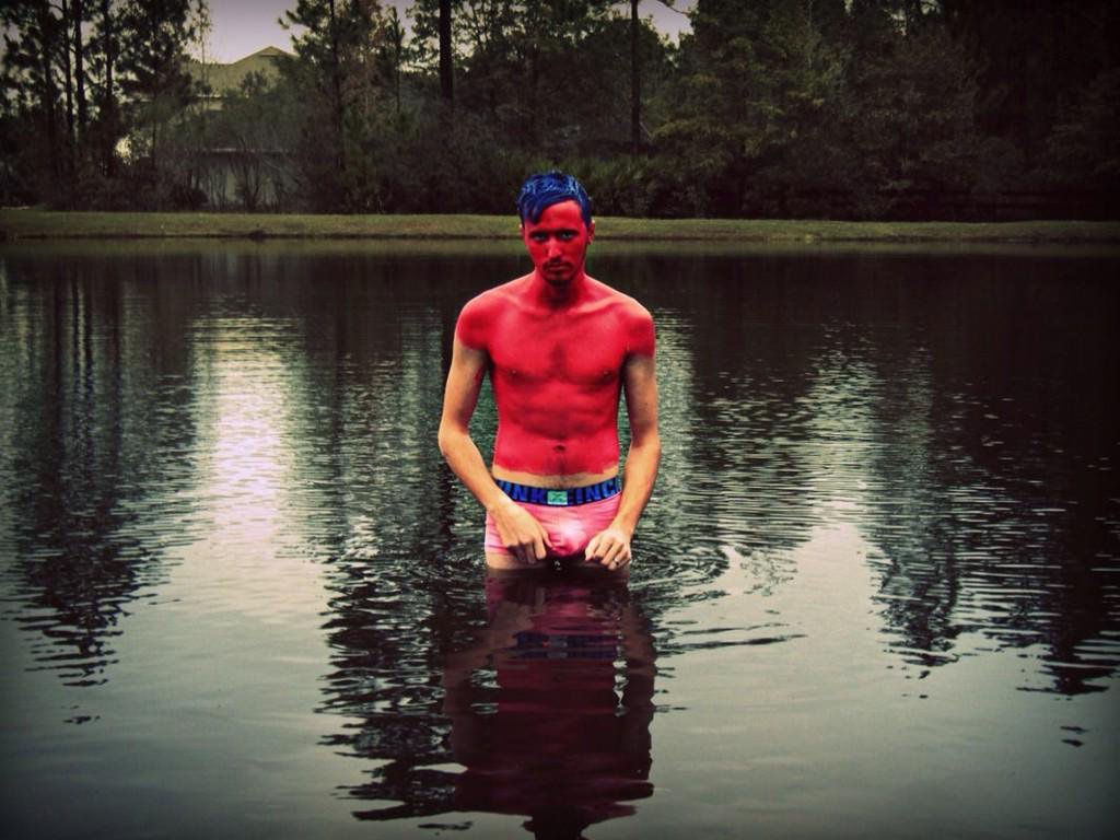 Artist Russell frantom stands in a pond 2010 