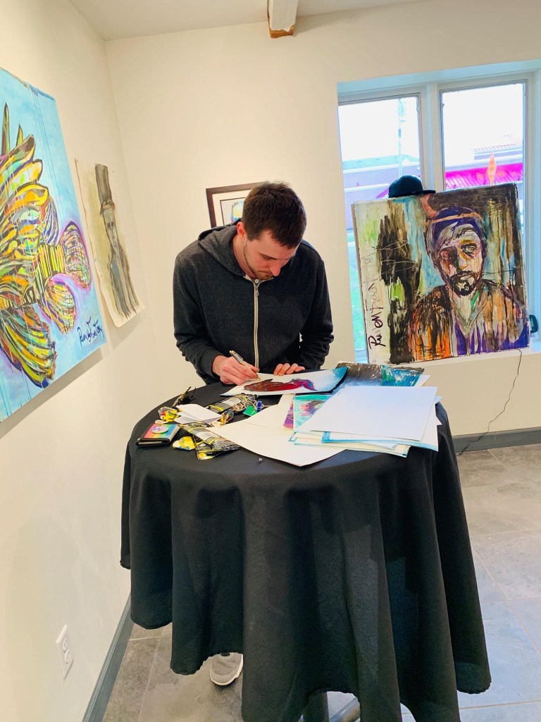 Artist Russell frantom in gallery signing lithographs 2019 ​