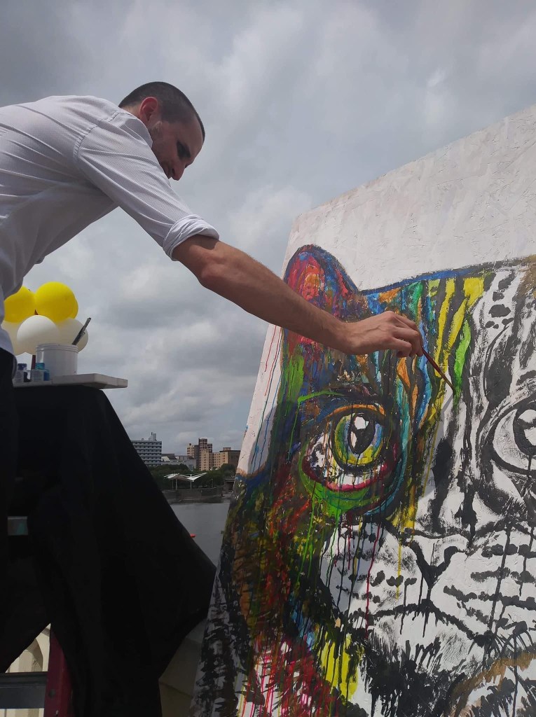 Artist Russell frantom paints a cat at south bend Indiana art beat in 2019 