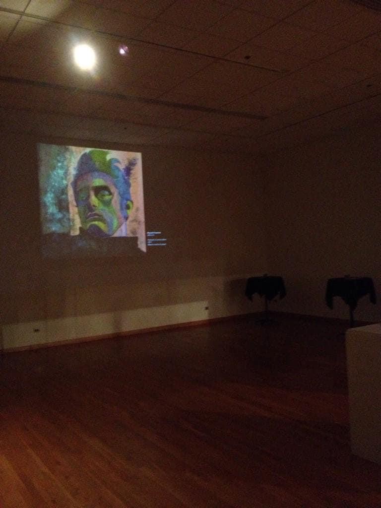 Artist Russell Frantom’s james Dean painting is projected onto a gallery wall at the south bend museum of art 